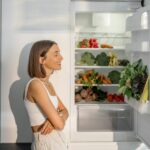 Woman with healthy vegetables in the fridge